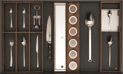 Elegant stainless steel utensils and knife displayed in a kitchen drawer organizer.