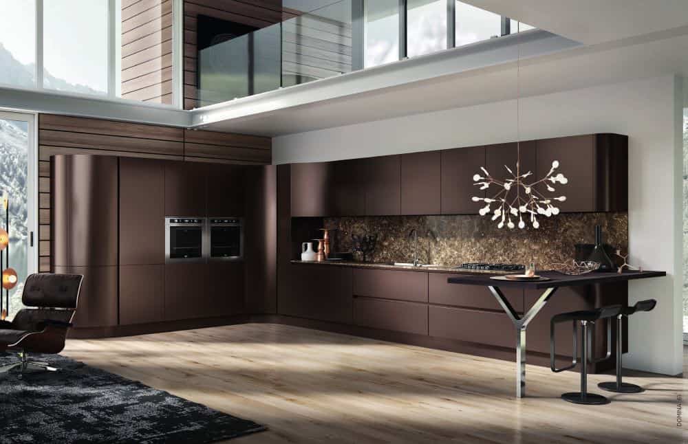 Modern brown kitchen with sleek cabinetry, large windows, and contemporary lighting fixture. Spaciou.