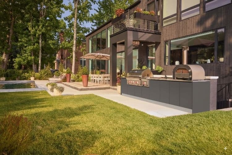 Urban home with outdoor kitchen, patio, and lush green lawn in a contemporary residential setting.
