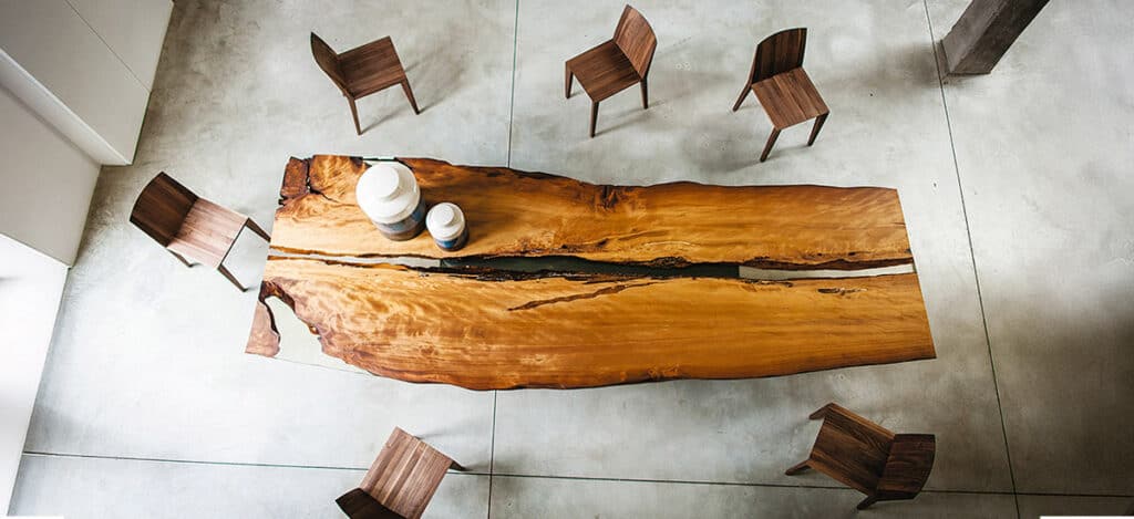 Elegant wooden dining table with Riva 1920 furniture in a contemporary home setting.