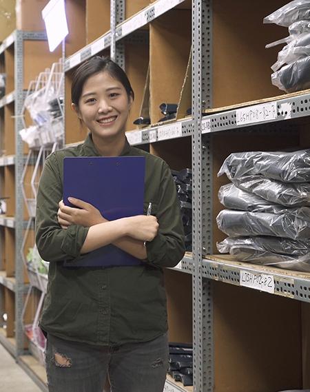 customer support representative standing in a uniform warehouse