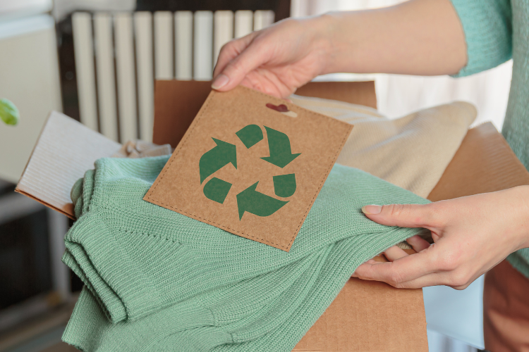 Recycled tag on top of apparel items in a box