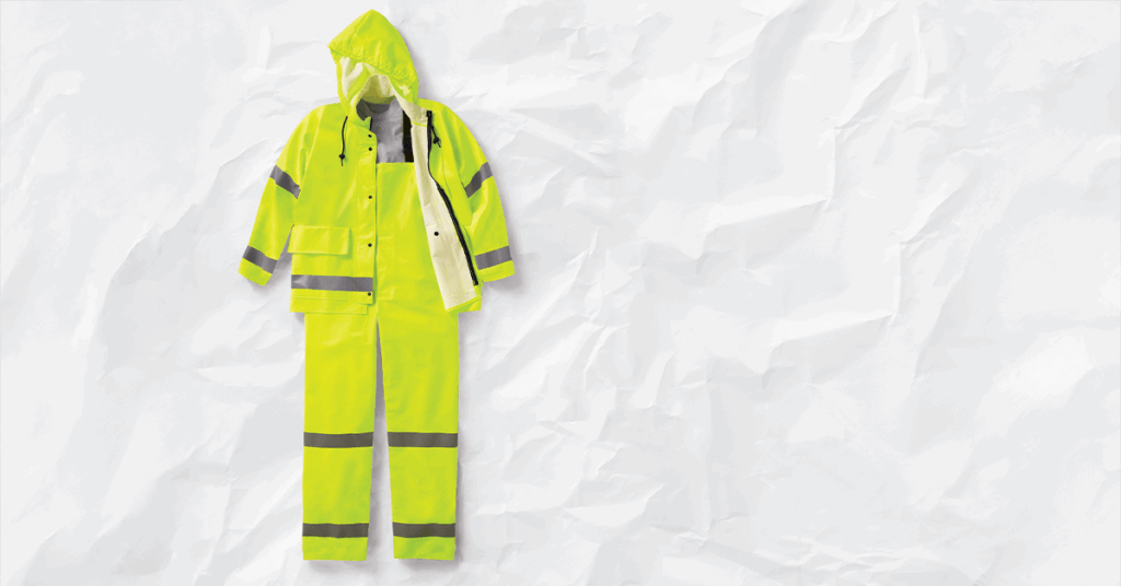 A yellow waterproof jacket and bib pants with reflective silver stripes, representing the critical Outer Shell layer required for ANSI/OSHA cold stress prevention and outdoor work safety.