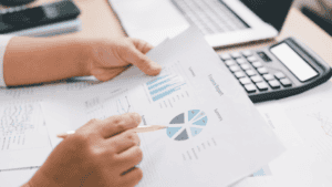 Finance team reviewing a year end uniform budget report with charts and spending summary