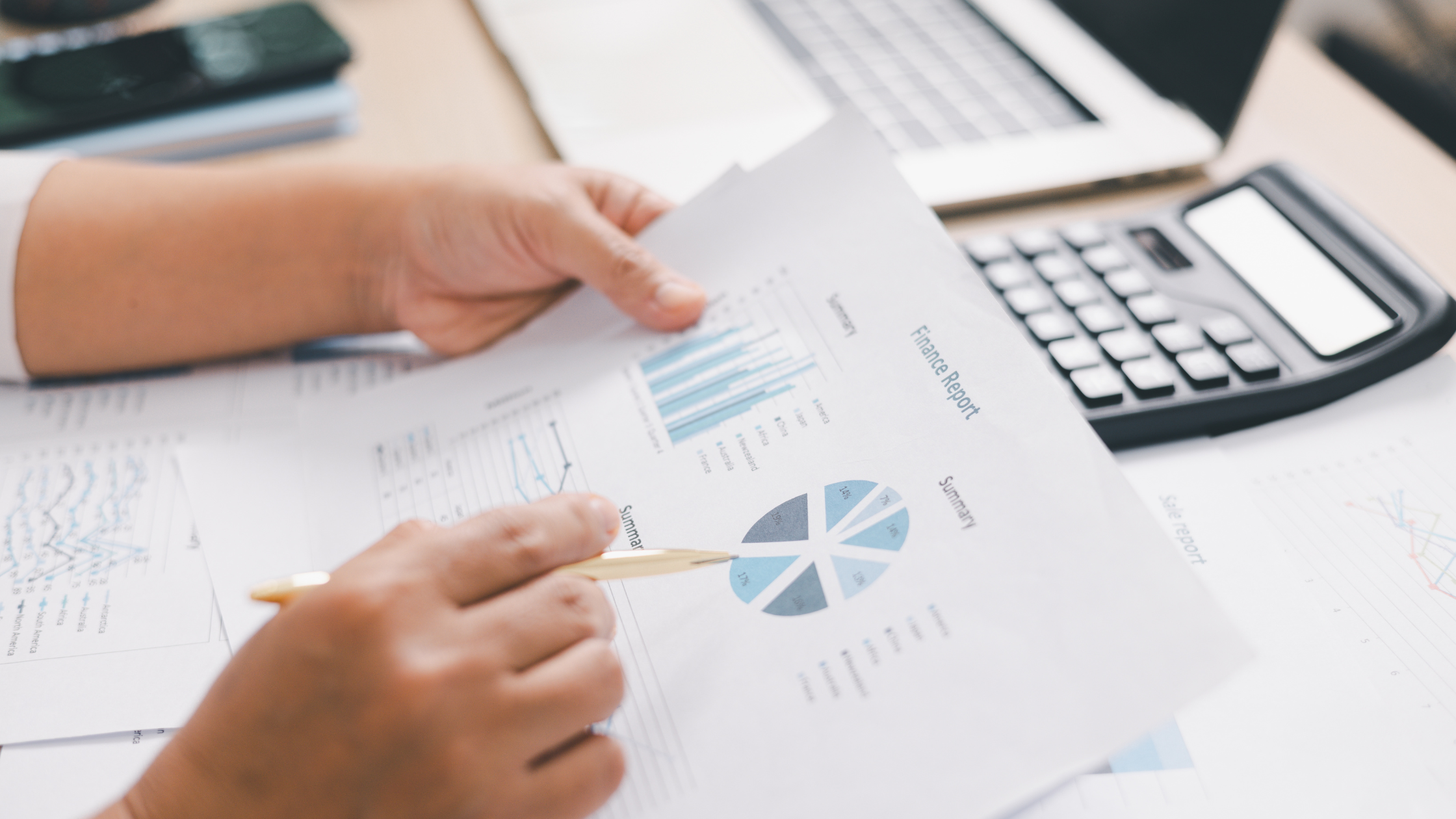 Finance team reviewing a year end uniform budget report with charts and spending summary