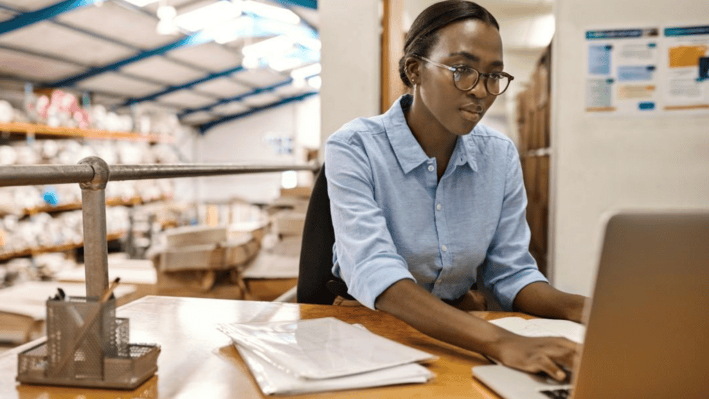 Uniform program administrator working at her desk managing orders and approvals