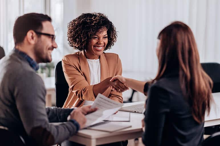 An agent shaking hands with a client
