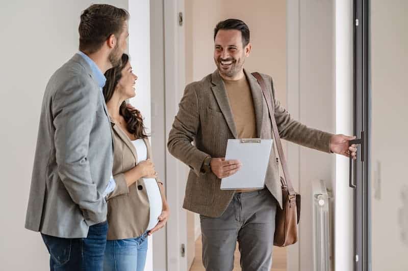 Insurance agents meeting in an office hallway