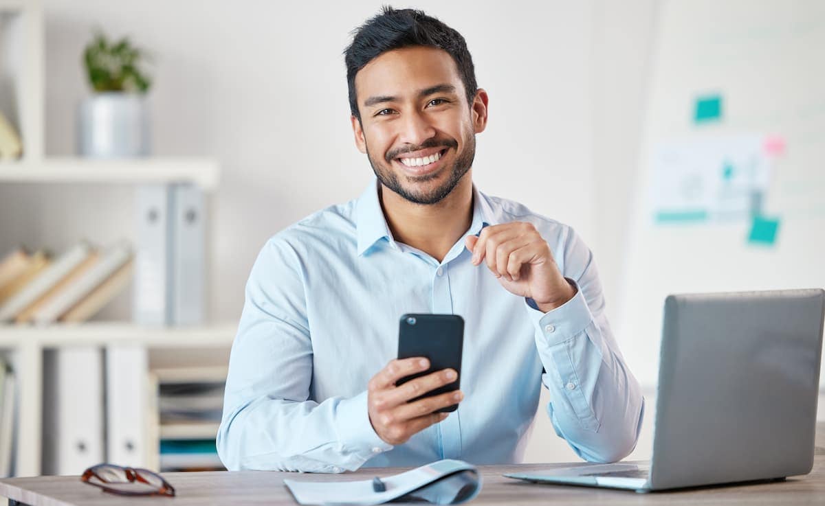 Independent Insurance agent sitting with laptop and phone