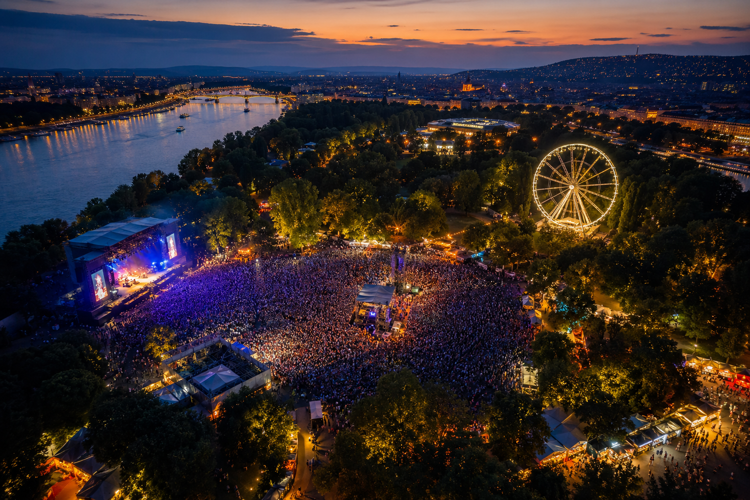 Aerial view of a massive outdoor music festival at sunset with a glowing Ferris wheel beside a river