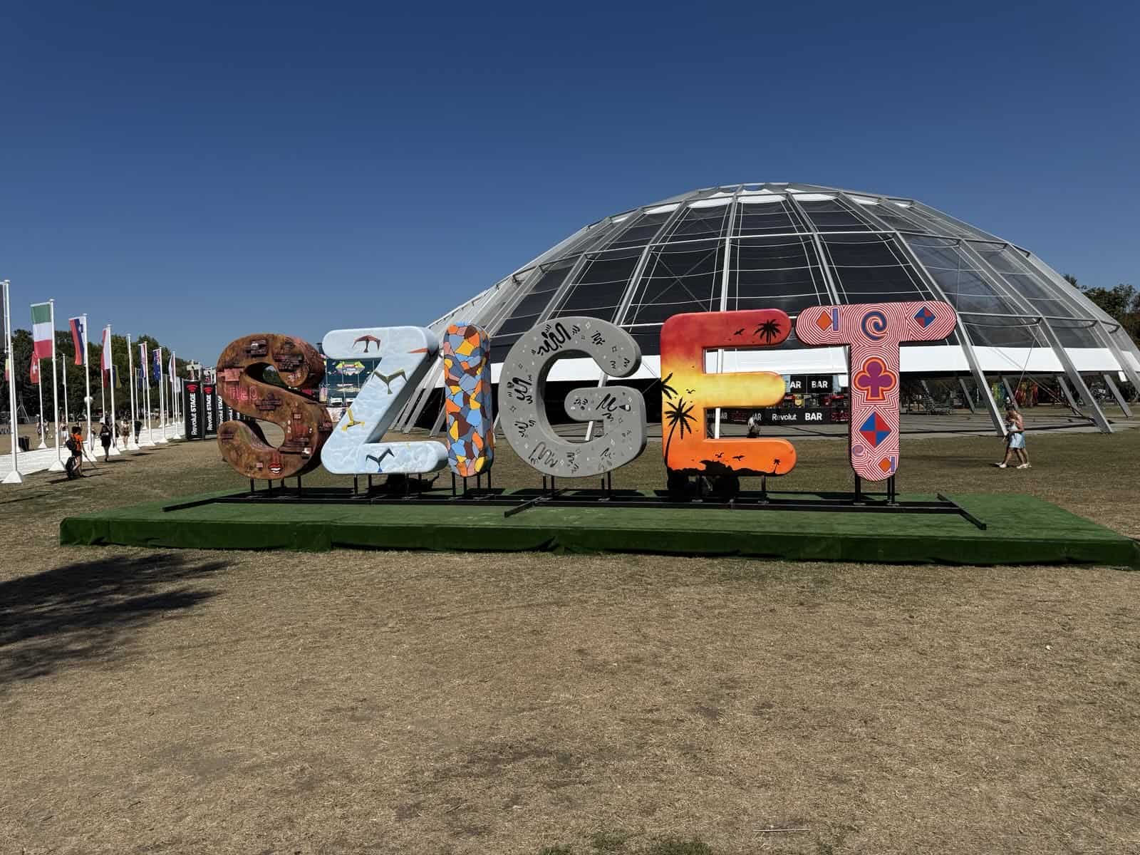 BUDAPEST colorful art installation with geodesic dome building and international flags at Hungarian