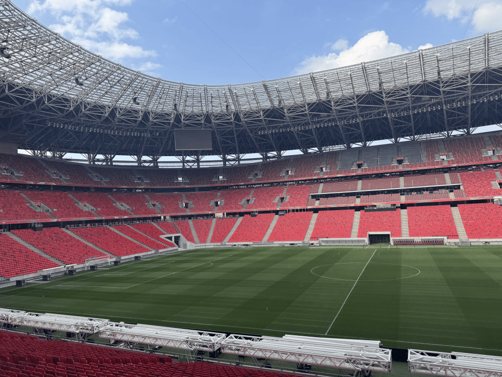 A diagonal view across the pitch beneath Puskás Aréna’s roof.