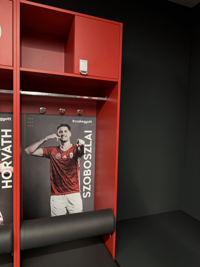 A red dressing-room locker with a portrait labeled Szoboszlai.