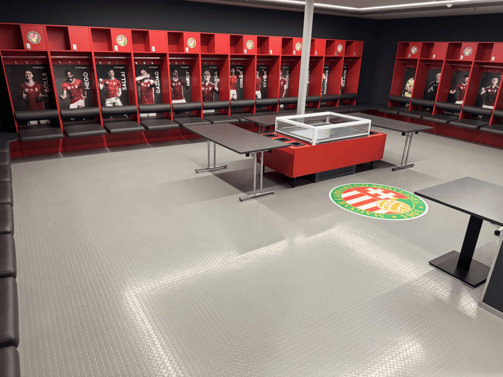 The Hungarian national-team dressing room at Puskás Aréna, with red player lockers.