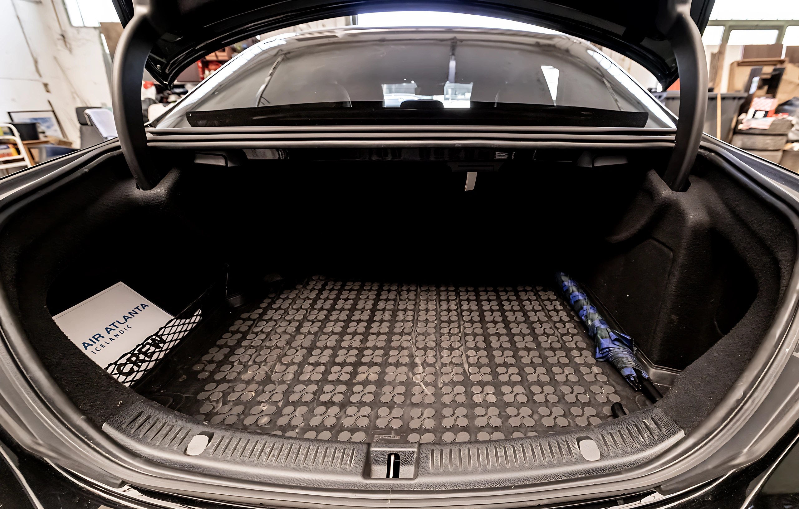 Open Mercedes-Benz E-Class luggage compartment prepared for an airport transfer