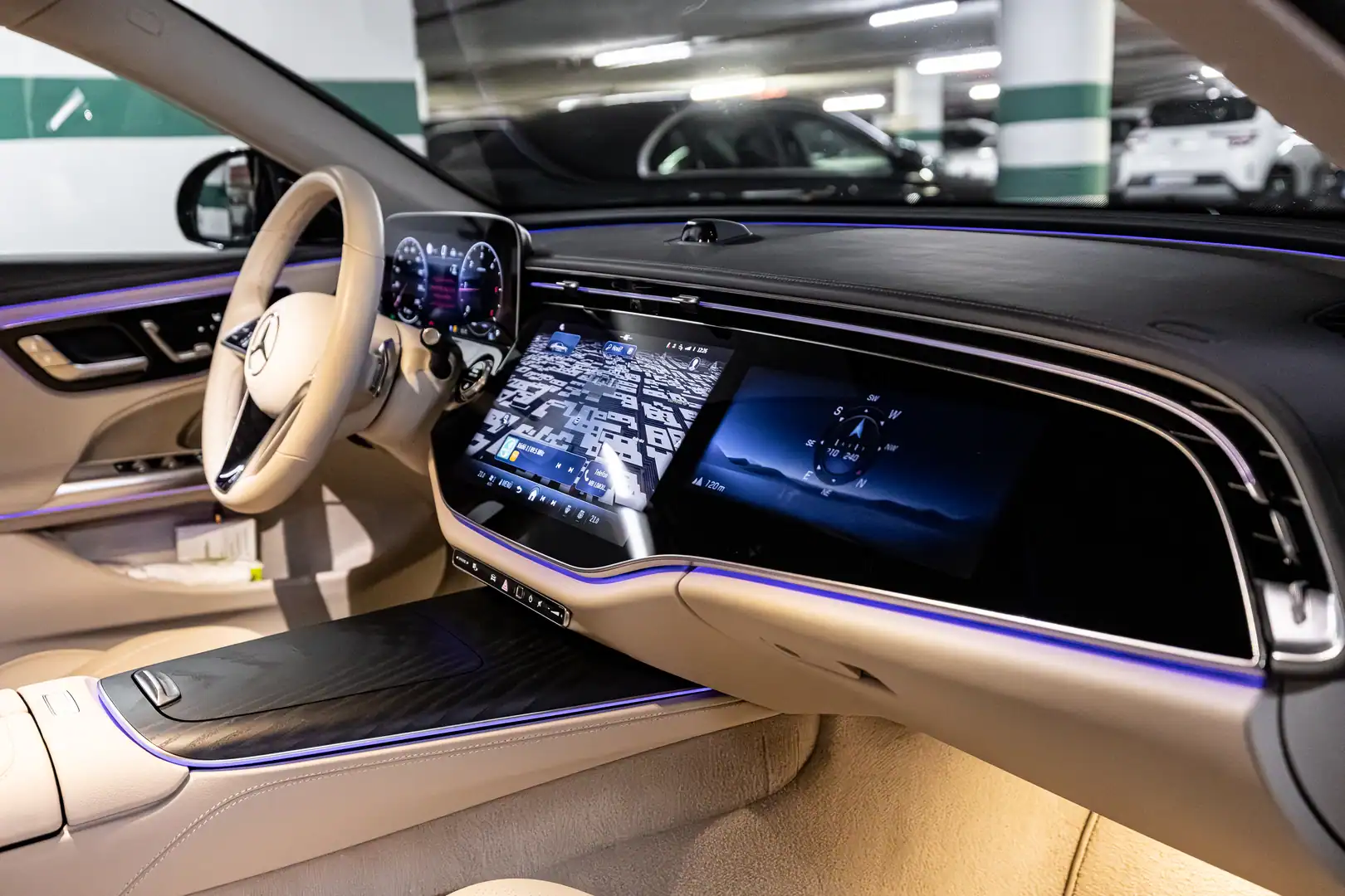 Cream-colored trim and illuminated dashboard in a Mercedes-Benz E-Class