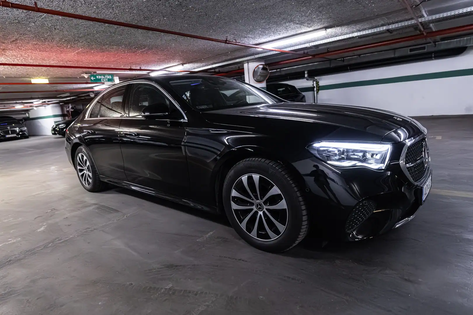 Black Mercedes-Benz E-Class sedan photographed in an indoor parking garage
