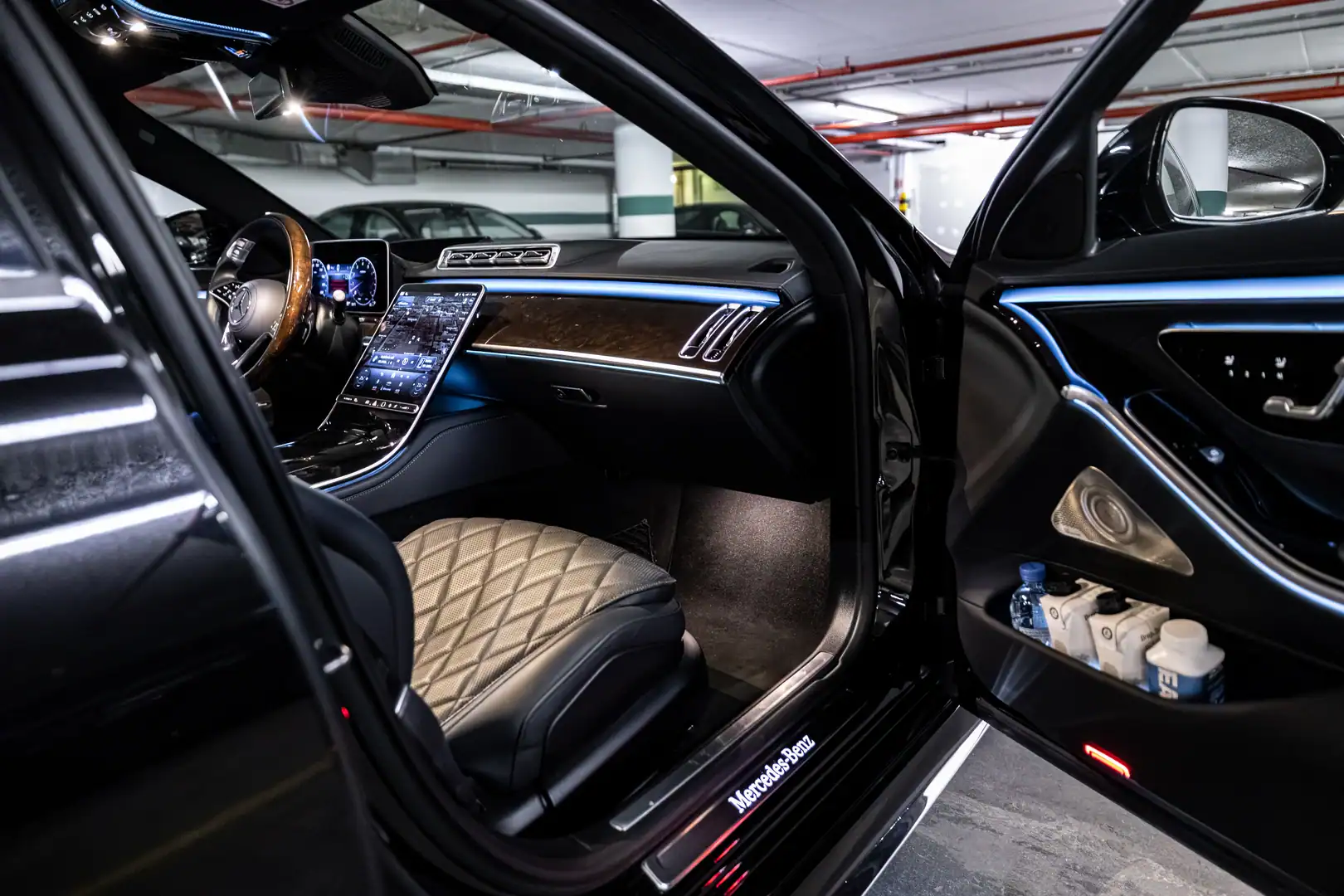Mercedes-Benz S-Class front cabin view with open door, ambient lighting and dashboard