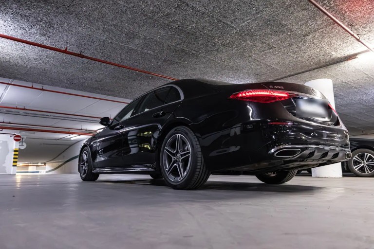 Black Mercedes S-Class, low-angle rear three-quarter view