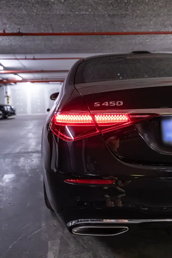 Rear close-up of a Mercedes-Benz S 450 with illuminated taillights