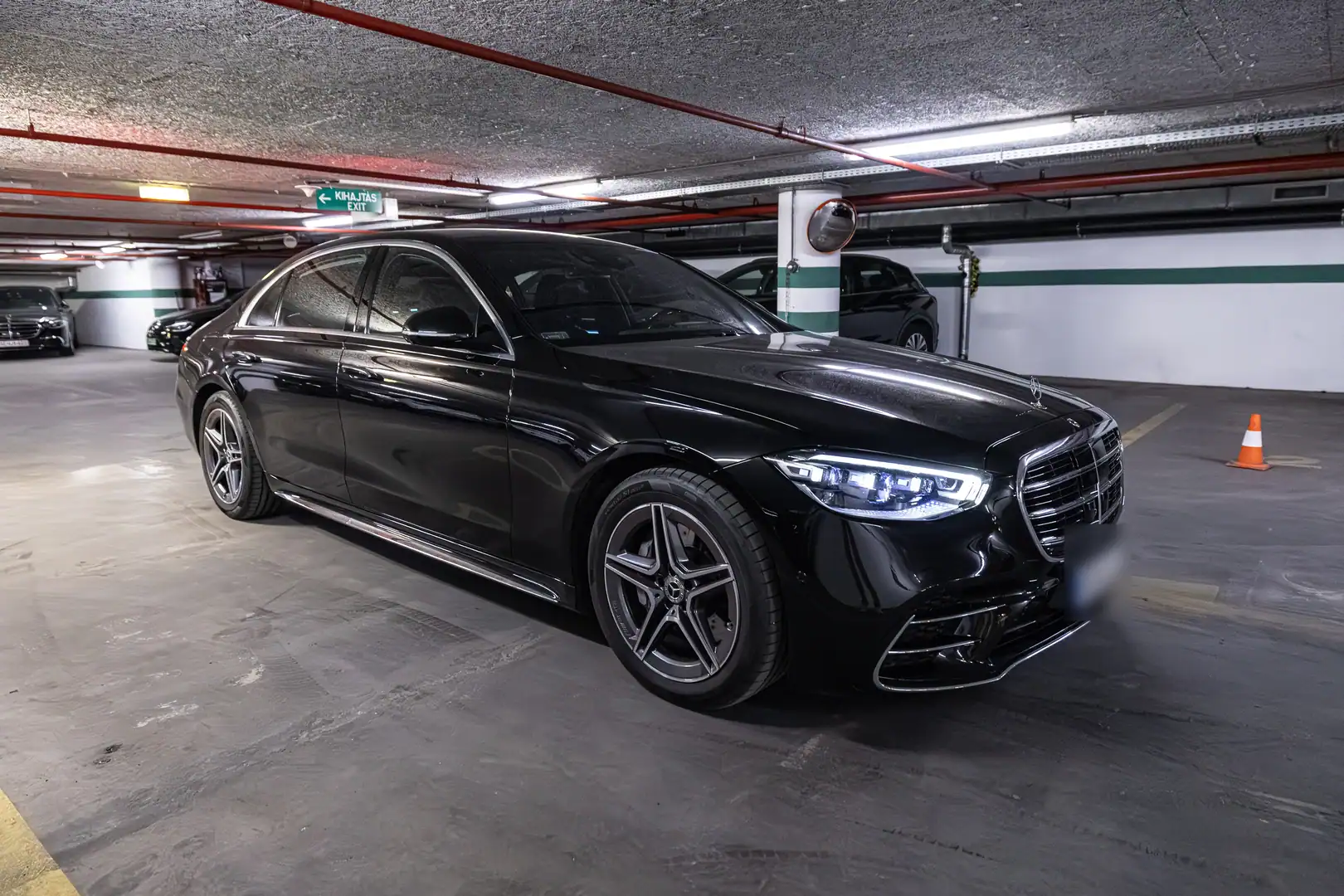 Black Mercedes-Benz S-Class front three-quarter view in a parking garage