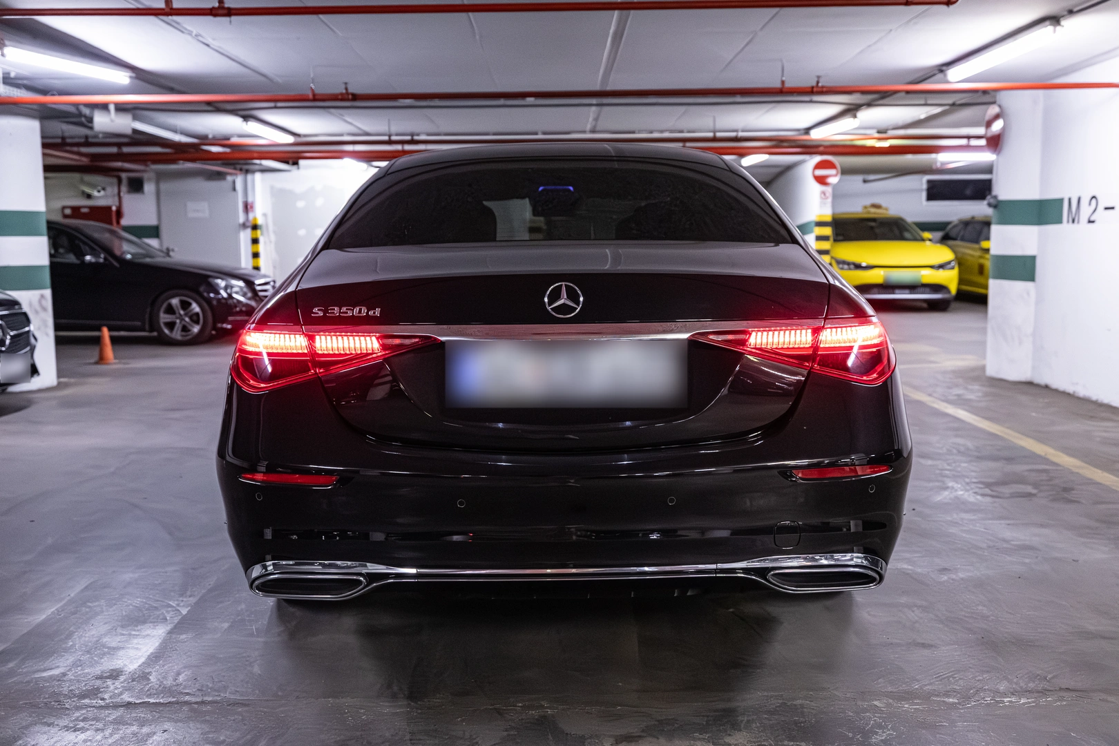 Black Mercedes-Benz S-Class rear view with illuminated taillights