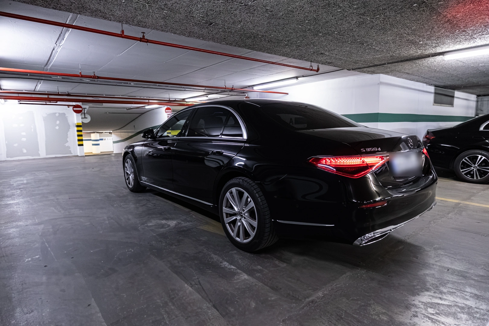 Black Mercedes-Benz S-Class rear three-quarter view
