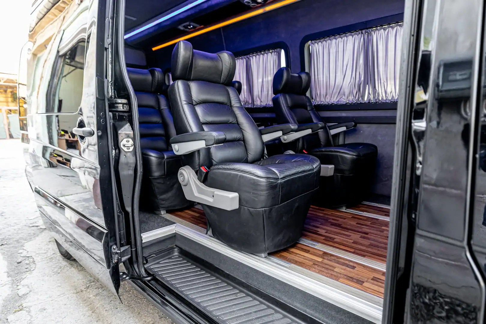 Mercedes VIP Sprinter passenger area — conference-style layout for corporate transfers