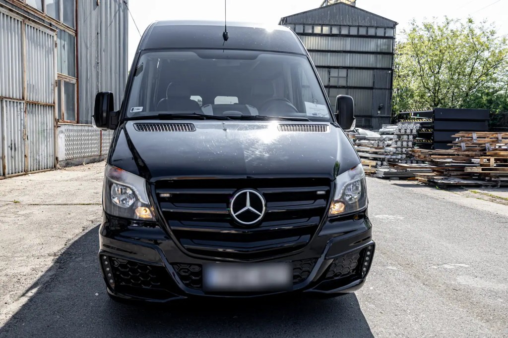 Front view of a black Mercedes-Benz Sprinter minibus