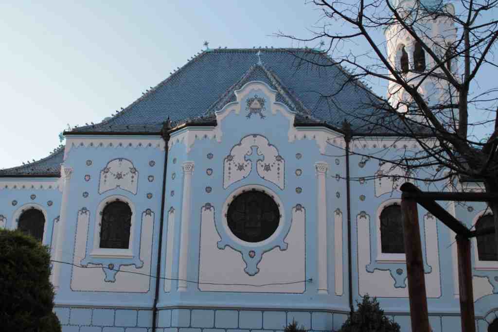 Pale blue facade and bell tower of the Blue Church in Bratislava