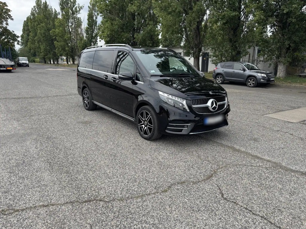 Black Mercedes-Benz V-Class parked in an outdoor parking area
