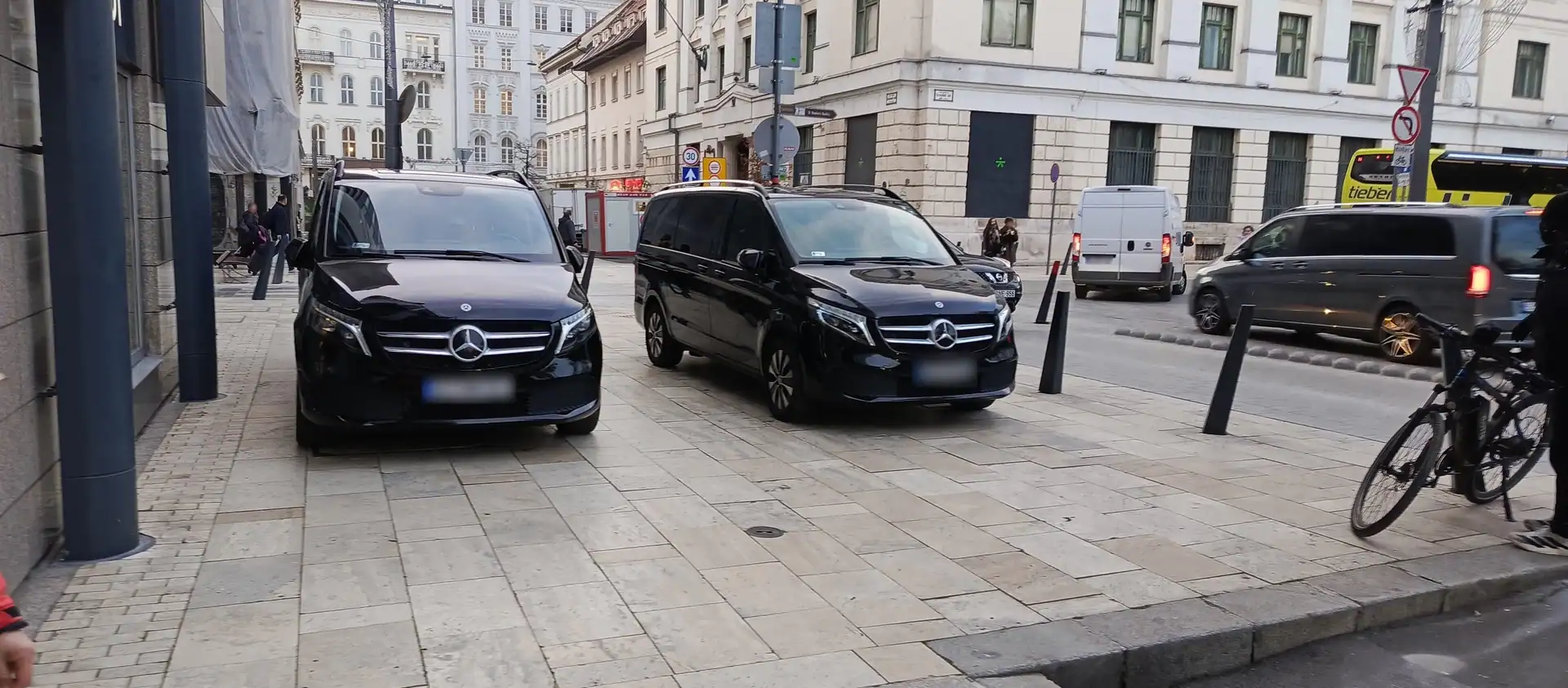 Two Mercedes-Benz V-Class vehicles parked outside a central Budapest hotel