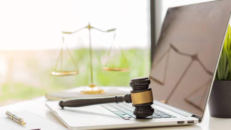 Gavel and laptop representing securities law and legal action.