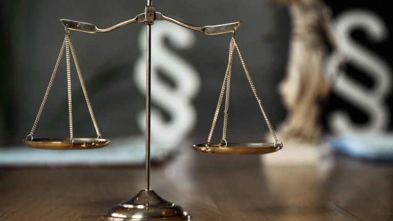Balance scales representing securities litigation and investment recovery.