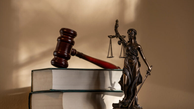 Justice statue with gavel and law books, symbolizing securities law and arbitration.