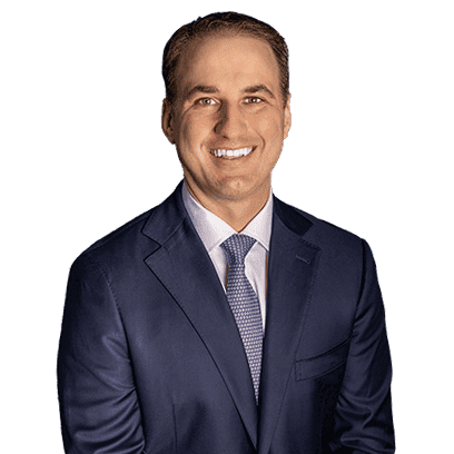 Experienced lawyer in a navy suit smiling for a professional photo at Varnavides Law, PC.