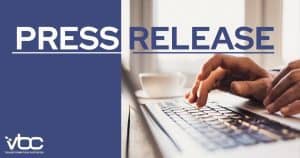 Hands typing on a laptop keyboard with the words "Press Release" prominently displayed above, highlighting VBC Transformation Partners' latest initiatives.