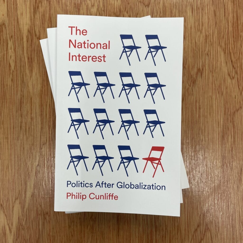 Chairs illustration with one red chair out of ten on the cover of a book titled "The National Interest" by Philip Cunliffe, focusing on global politics and nationalism.