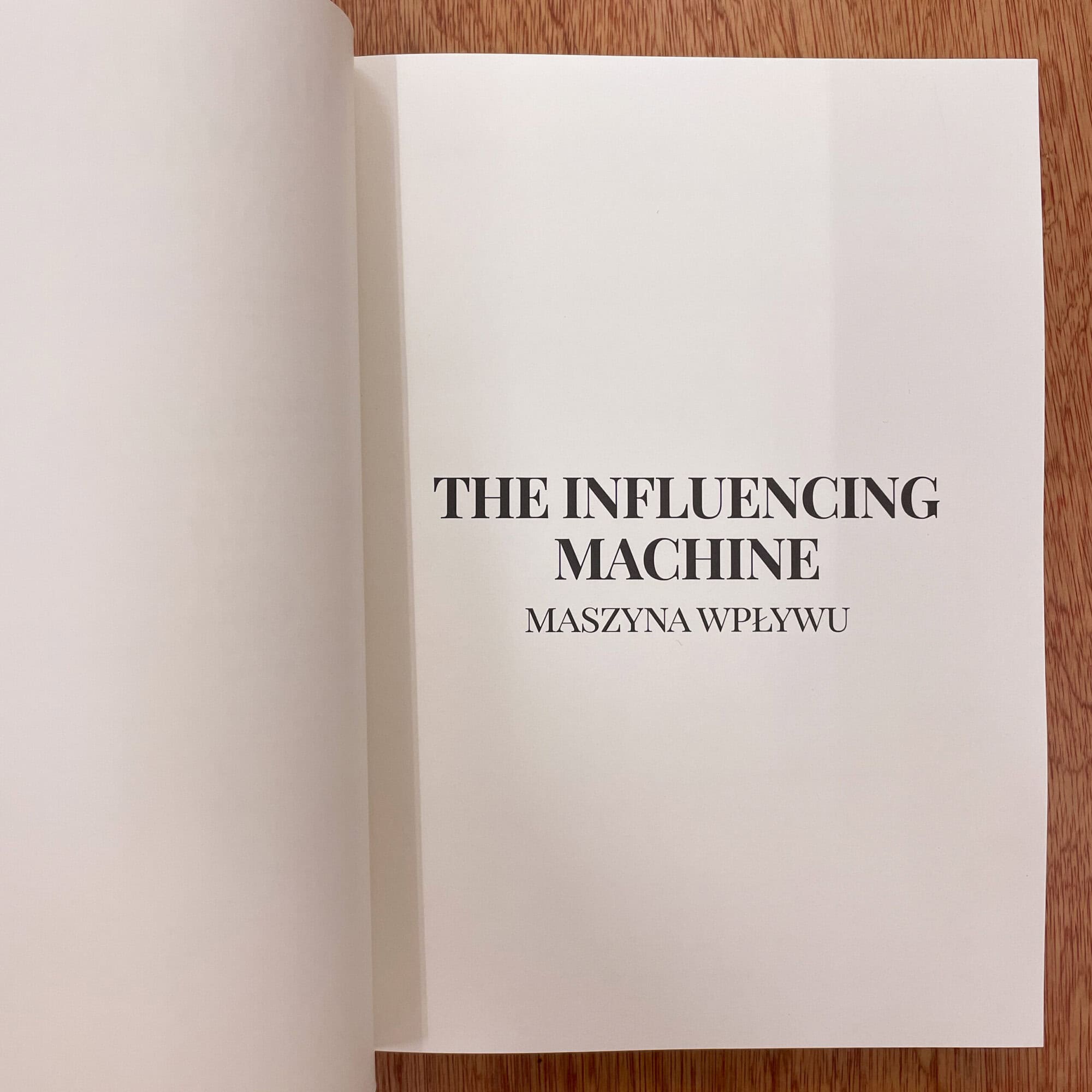 Open book displaying 'The Influencing Machine' by Maszyna Wplywu, related to visual culture and cultural questions.