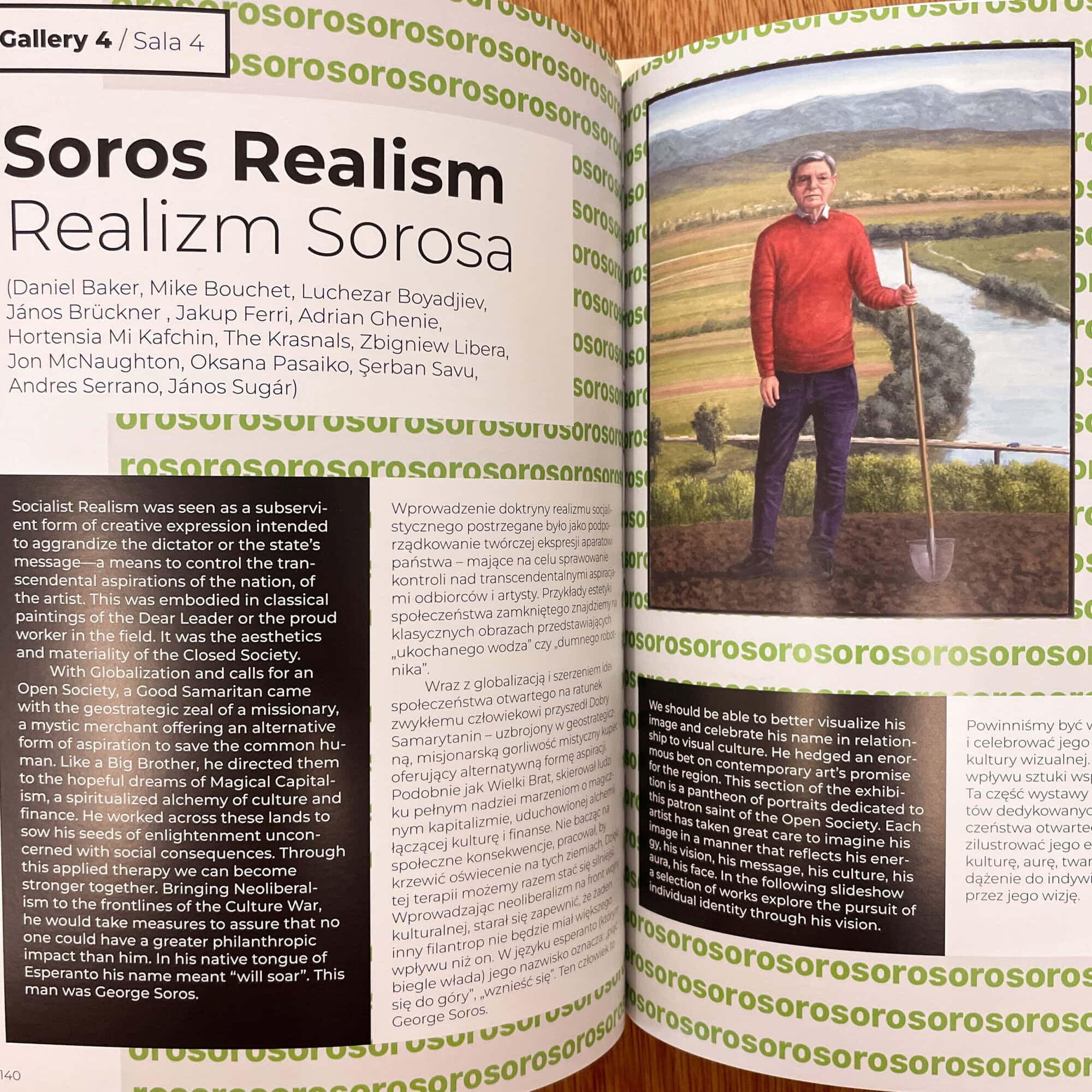 Photograph of a man standing by a pond in a rural landscape, with a red sweater and glasses, representing Soros Realism art theme at Verdurin.