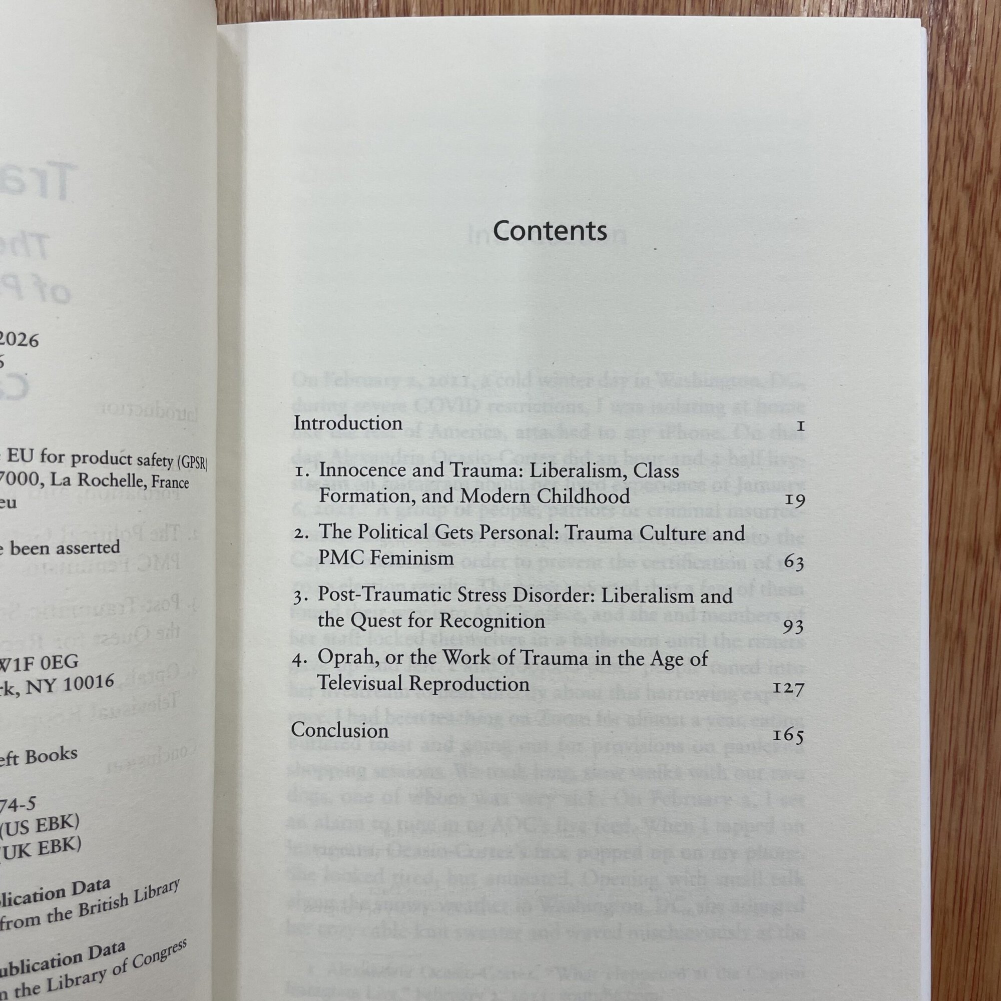 Open book showing contents page with topics on trauma, politics, and culture, related to 'Traumatized: The New Politics of Public Suffering' by Catherine Liu.