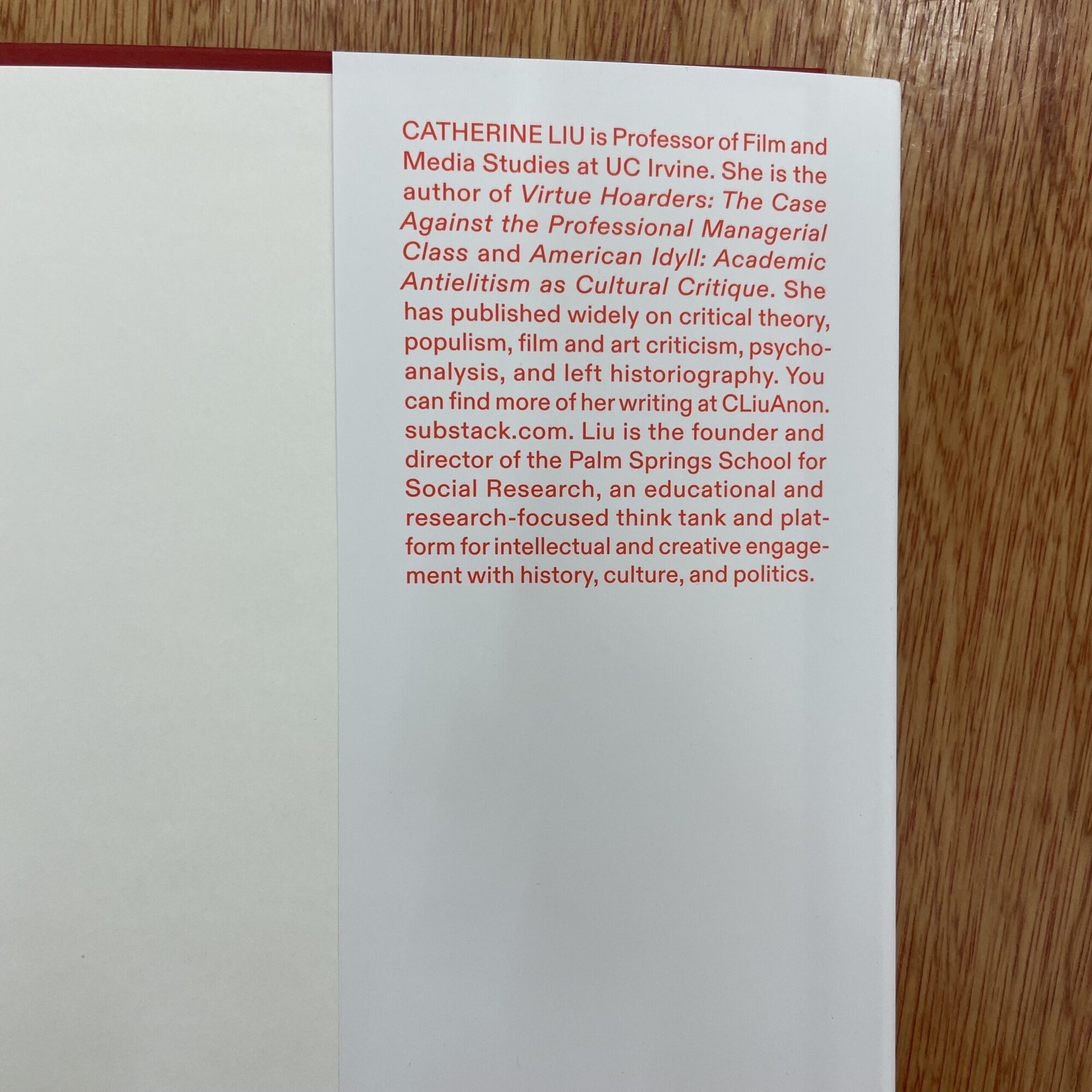 Close-up of a white page with red and black text about Catherine Liu, a professor of film and media studies.
