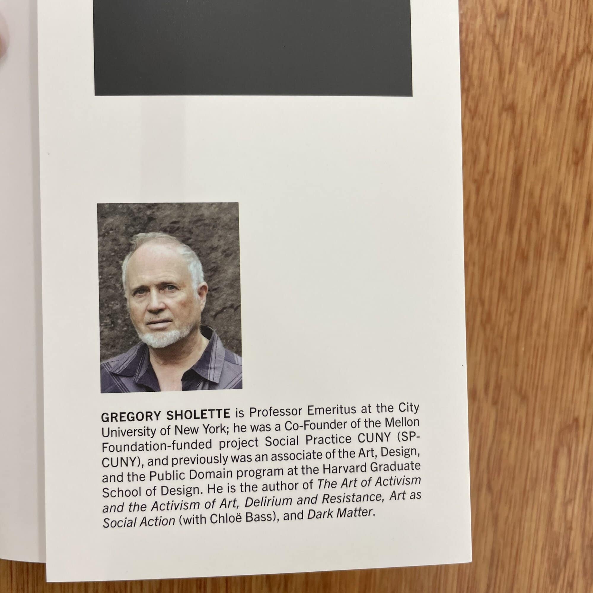 Photograph of Gregory Sholete, a professor and author, with a brief biography on a white background.