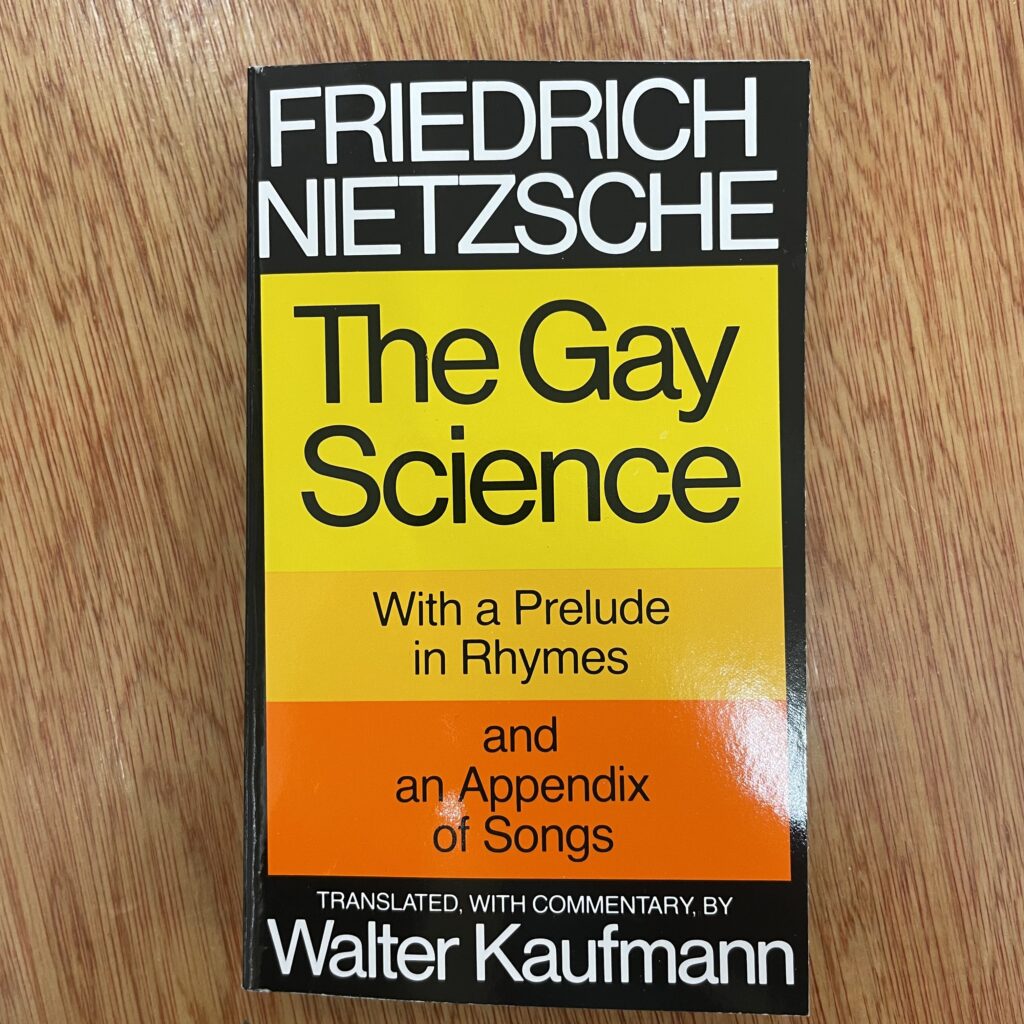Cover of Friedrich Nietzsche's 'The Gay Science' with a yellow, orange, and black design.