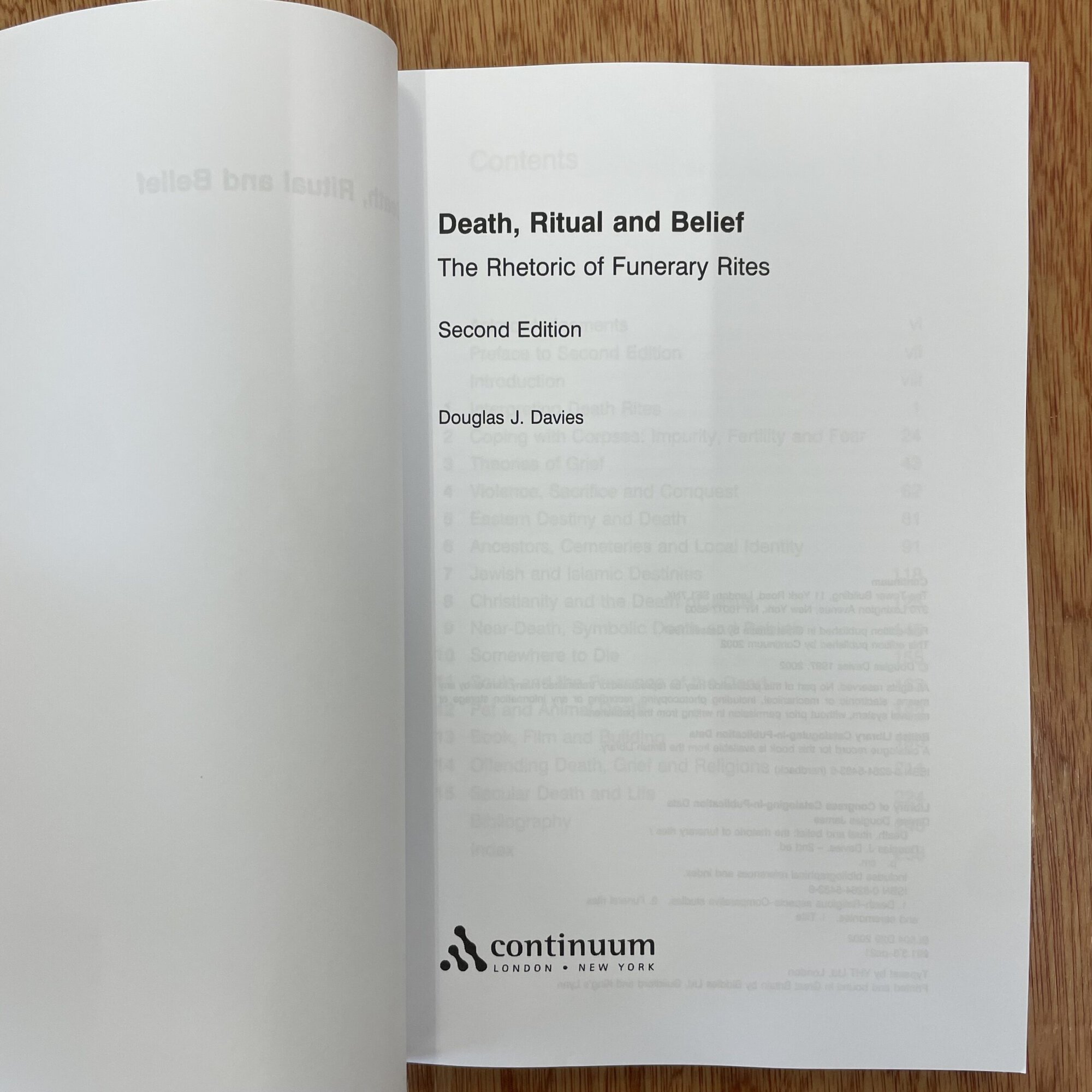 Open book titled 'Death, Ritual and Belief' by Douglas J. Davies, published by Continuum, focusing on funeral rites and cultural practices.