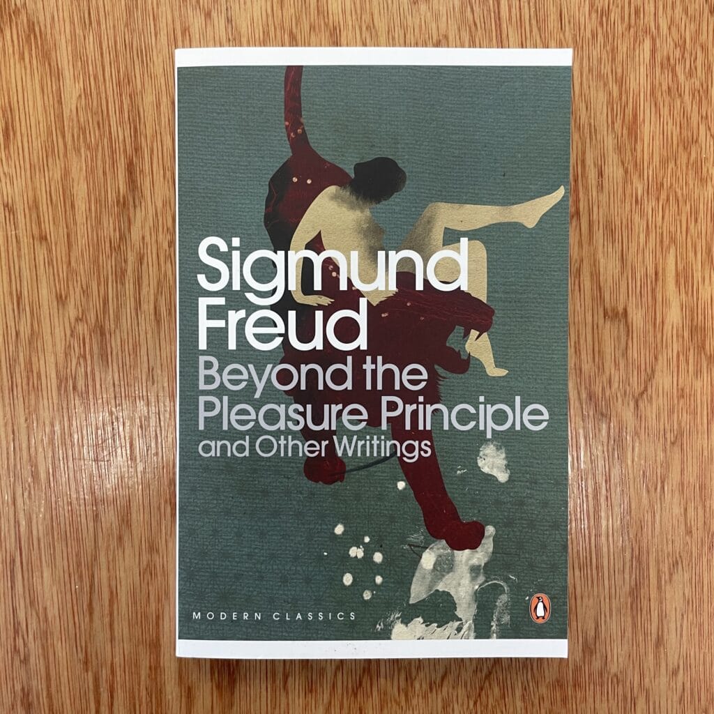 Cover of Sigmund Freud's 'Beyond the Pleasure Principle' showcasing modernist artwork with abstract human figures.