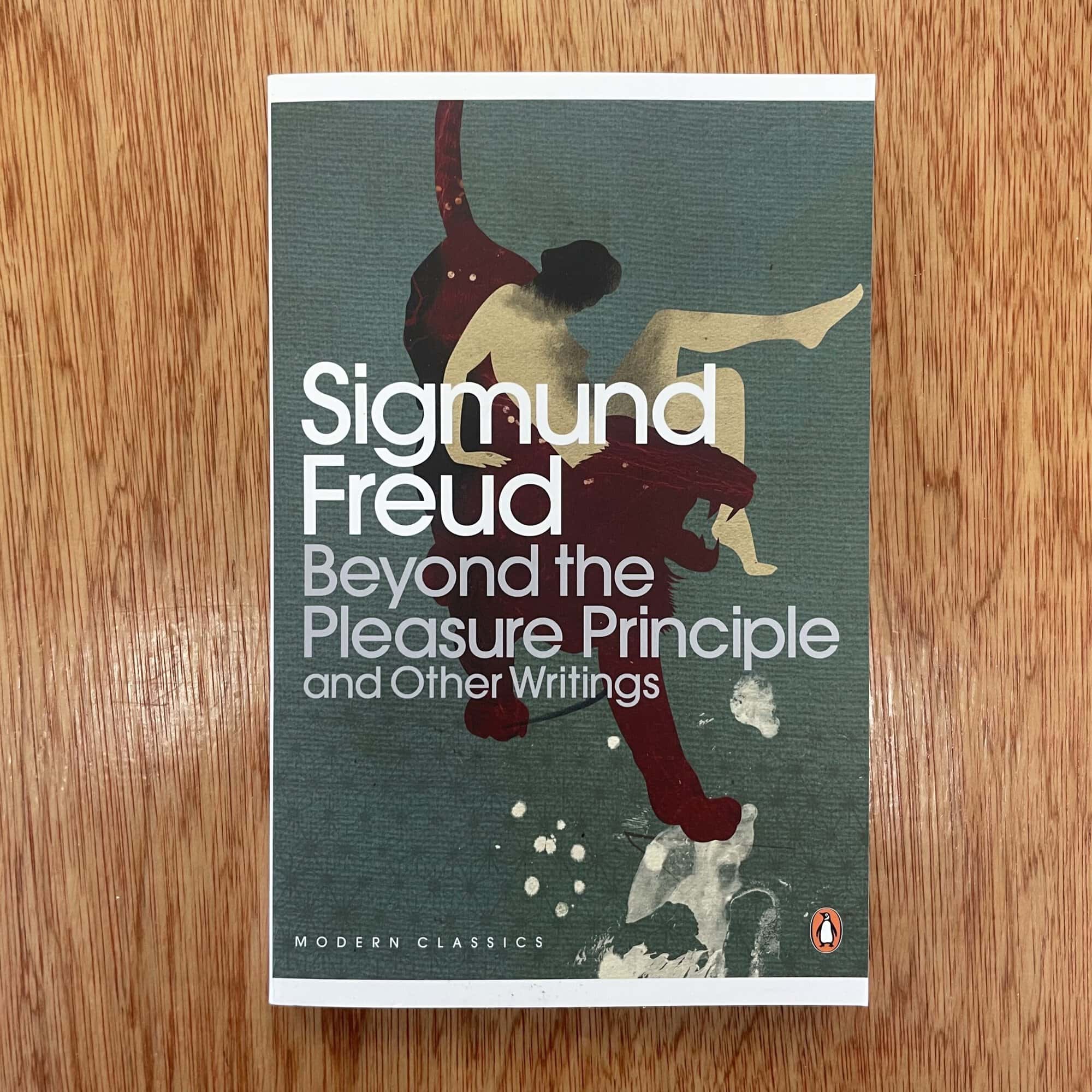 Cover of Sigmund Freud's 'Beyond the Pleasure Principle' showcasing modernist artwork with abstract human figures.