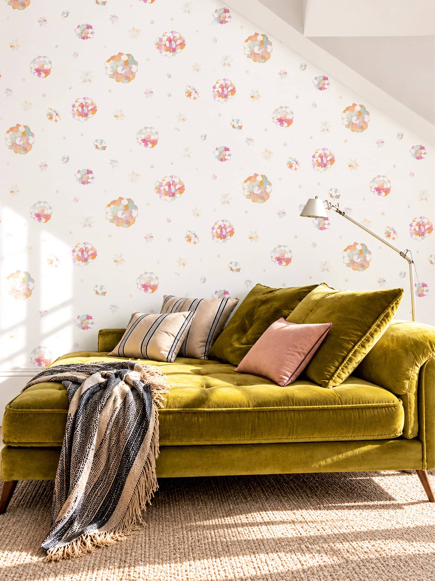Pastel floral wallpaper with pink, peach and mint watercolour blooms in an attic living room