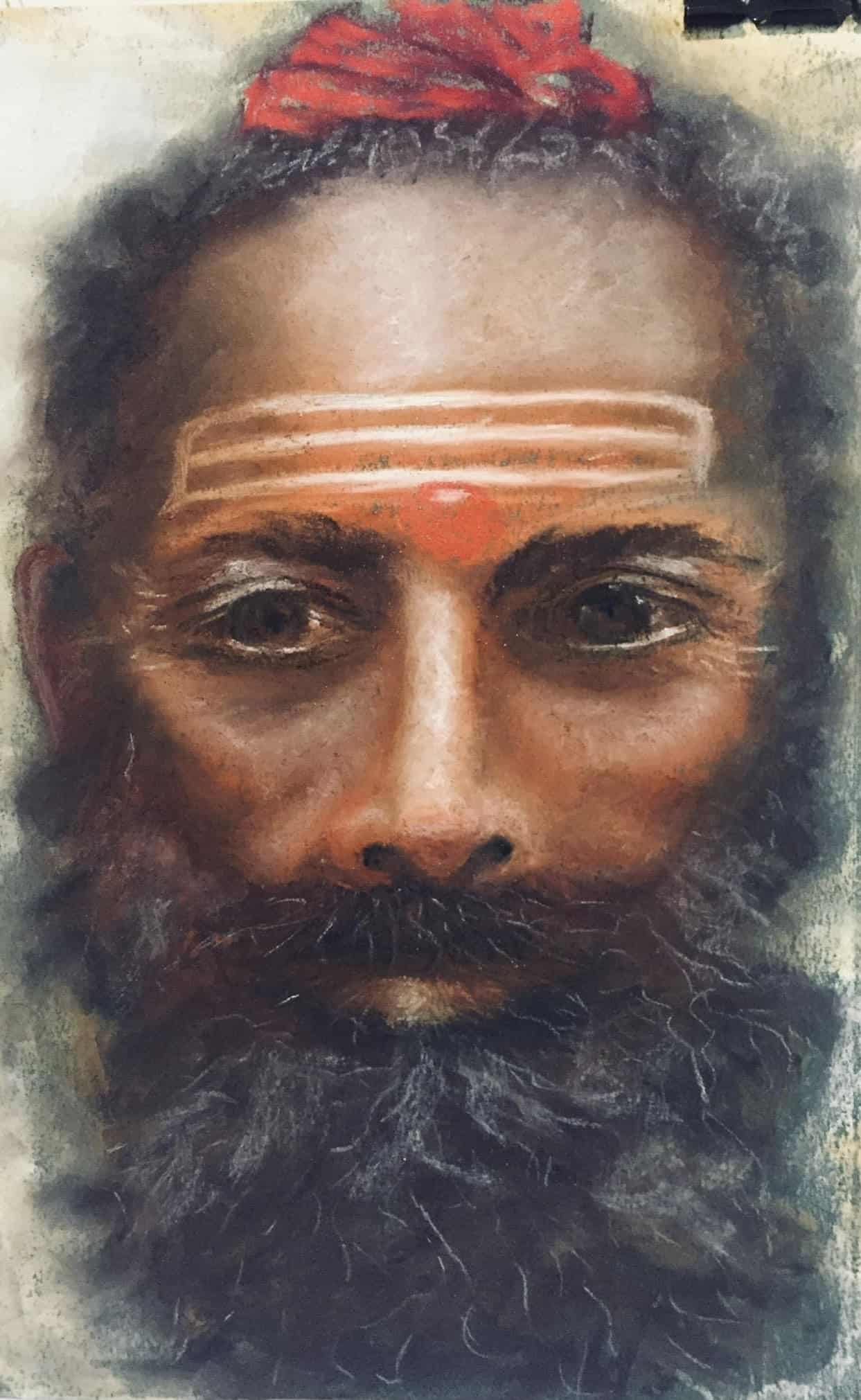 Close-up of Michelle Hendrie's face with traditional markings and a red headscarf.