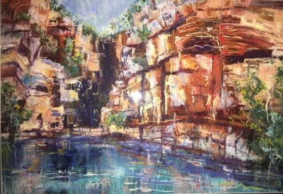 Vibrant canyon walls with reflected water in a pastel palette.